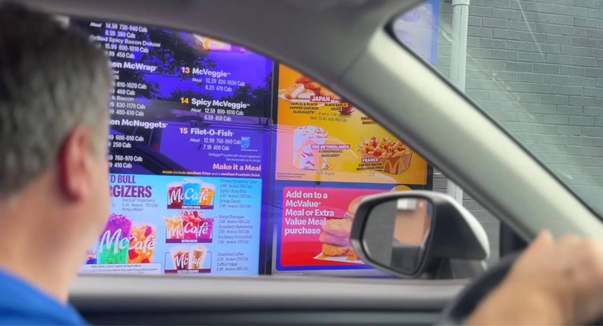 Digital drive-thru menu board seen from the driver’s seat