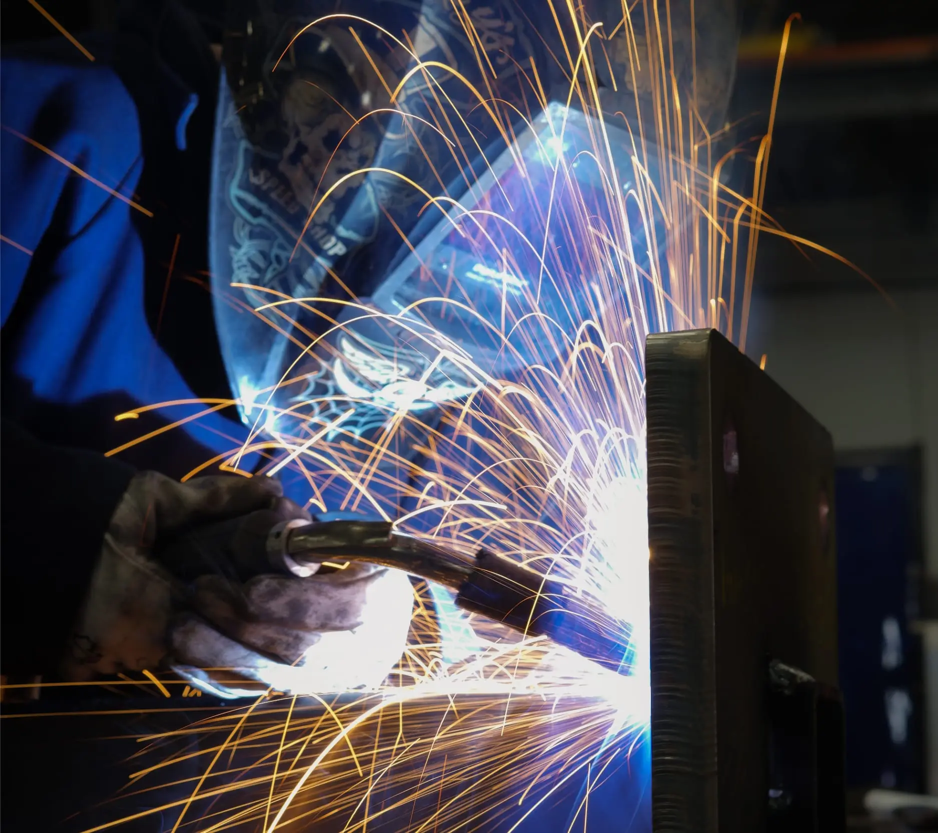 Welding sparks flying in the Pride Visual Solutions fabrication shop