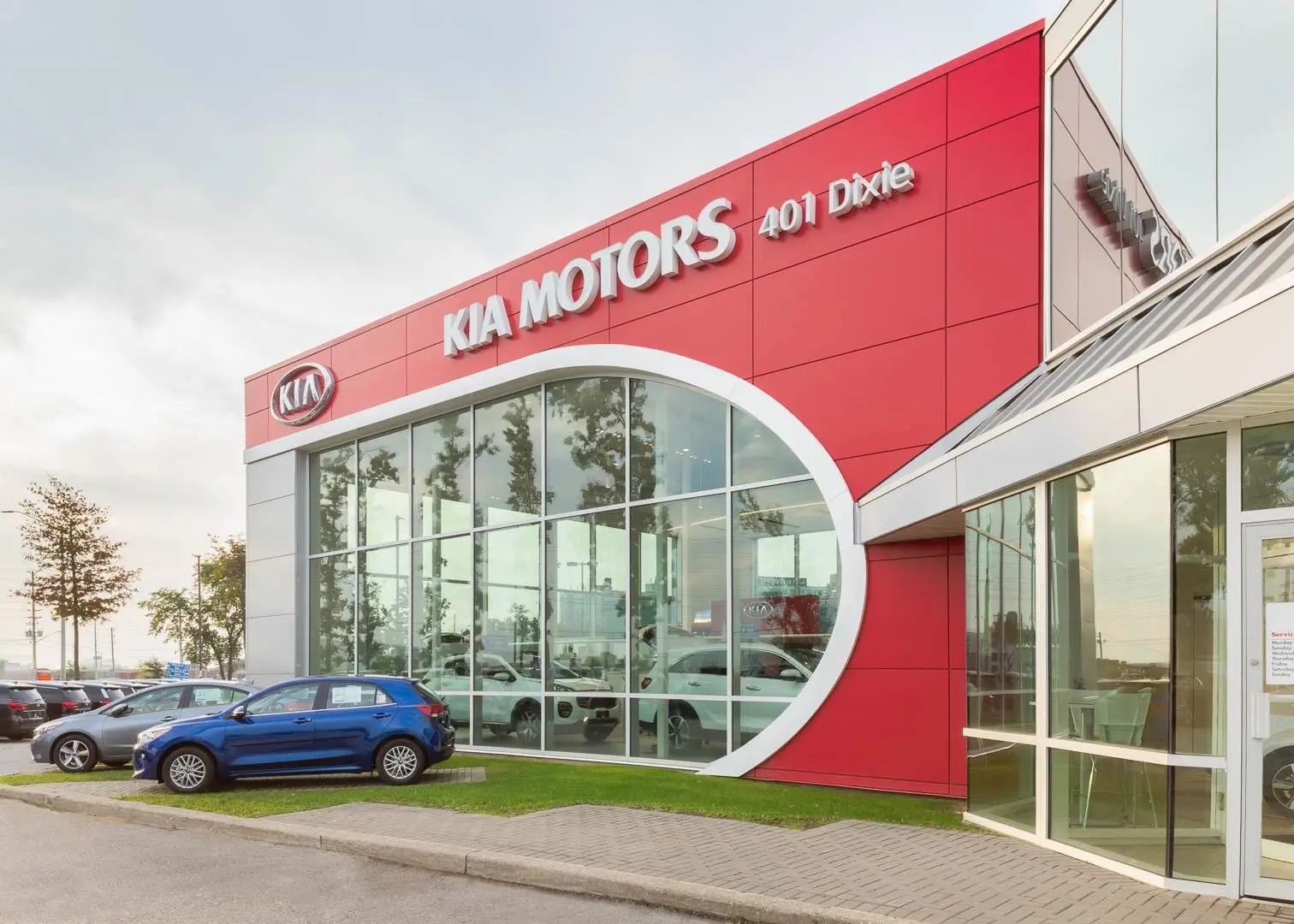 KIA dealership exterior with architectural cladding and dimensional logo