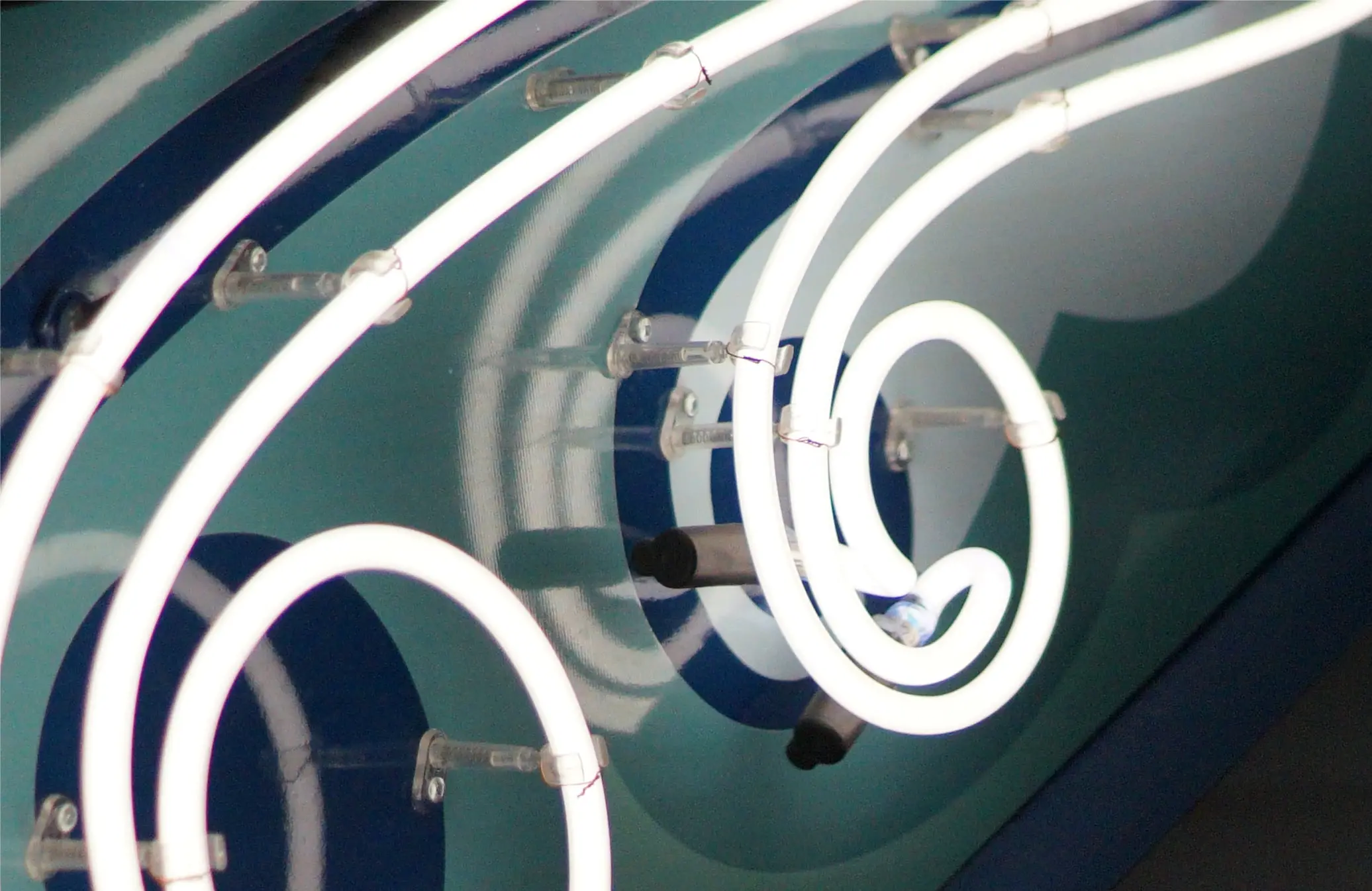 Close-up of illuminated tubing inside a sign face during a service visit