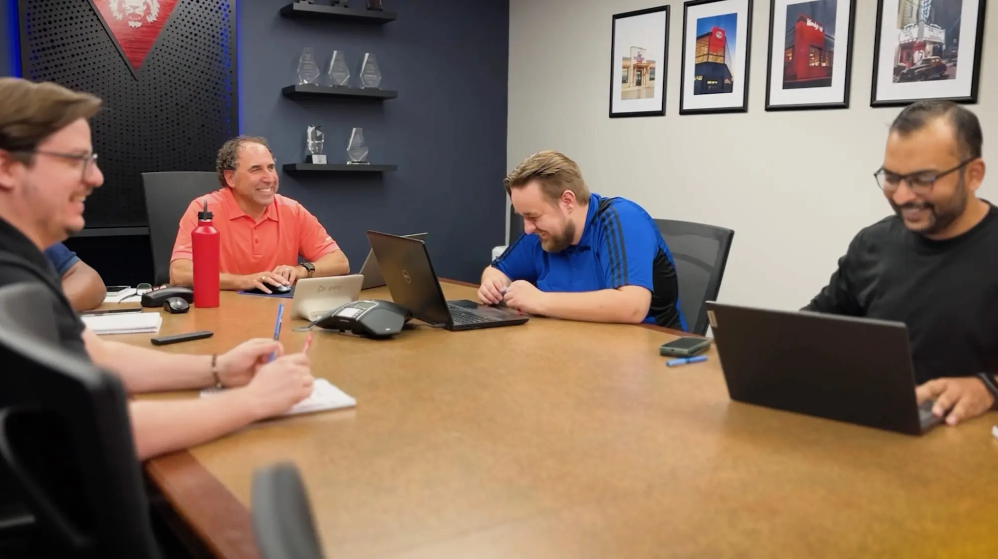 Pride Visual Solutions team members meeting with a client